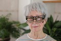Senior woman wearing three eyeglasses simultaneously Royalty Free Stock Photo