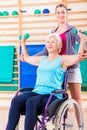 Senior woman in wheel chair doing physical therapy Royalty Free Stock Photo