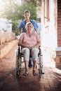 Senior woman, wheelchair and caregiver in portrait for homecare, healthcare service and disability support outdoor Royalty Free Stock Photo