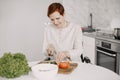 Mature disabled woman cutting vegetables in the kitchen Royalty Free Stock Photo