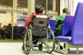 Senior woman in wheelchair with daughter at departure gate.