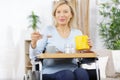 senior woman in wheelchair holding cup Royalty Free Stock Photo