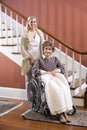 Senior woman in wheelchair at home with nurse Royalty Free Stock Photo