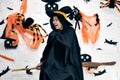 Senior woman in witch costumes celebrating Halloween laughing on broom