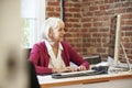 Senior Woman Working At Computer In Contemporary Office Royalty Free Stock Photo