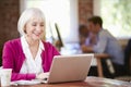 Senior Woman Working At Laptop In Contemporary Office Royalty Free Stock Photo