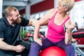Senior woman working out with dumbbells with personal trainer Royalty Free Stock Photo