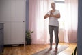 Senior woman working out indoors standing in Tadasana, Mountain Pose. Royalty Free Stock Photo
