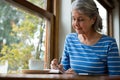 Senior woman writing in a diary