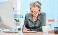 Senior woman, writing and schedule in office with music headphones at desk, reading or focus. Elderly secretary Royalty Free Stock Photo