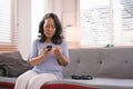 A senior woman& x27;s hand checking her blood sugar level with a glucometer by herself at her home. Royalty Free Stock Photo