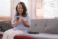 A senior woman& x27;s hand checking her blood sugar level with a glucometer by herself at her home. Royalty Free Stock Photo