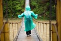 Senior woman 60 years old Crossing River by hinged bridge in forest Royalty Free Stock Photo