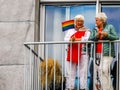 Two senior women on the balcony holding a LGBT rainbow flag, gay pride antwerp, 10 august, 2019, Antwerpen, Belgium