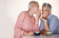 Senior women, bonding or whispering secrets in coffee shop, restaurant or cafe and funny gossip, news or story. Smile