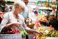 Mature woman buying vegetables at farmers market