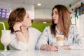 Senior women close friends sitting in cafe bar or restaurant enjoying in conversation