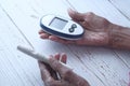 Senior women diabetic measure glucose level at home