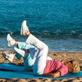 Senior women doing leg exercises on beach. Royalty Free Stock Photo