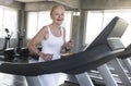 Senior women exercise jogging at gym fitness smiling and happy. elderly healthy lifestyle