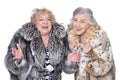 senior women in fur coats isolated on white background Royalty Free Stock Photo