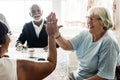 Senior women giving each other high five Royalty Free Stock Photo