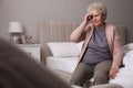 Senior woman with headache in bedroom at home Royalty Free Stock Photo