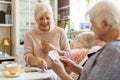 Senior woman and her adult daughter playing cards Royalty Free Stock Photo