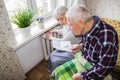 Woman holding cash in front of heating radiator. Payment for heating in winter. Selective focus.