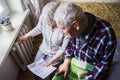 Woman holding cash in front of heating radiator. Payment for heating in winter. Selective focus.