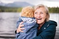 Senior woman with little boy at the lake. Royalty Free Stock Photo