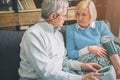 Senior woman is measuring her blood pressure with a special devi