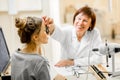 Senior woman ophthalmologist with patient in the office Royalty Free Stock Photo