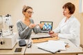 Senior woman ophthalmologist with patient in the office Royalty Free Stock Photo