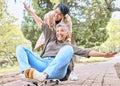 Senior women, park and couple of friends together outdoor for comic fun on a skateboard while happy. People together in Royalty Free Stock Photo