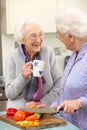 Senior women preparing meal together