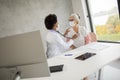 Senior woman with protective facial mask having a medical exam by black female doctor Royalty Free Stock Photo