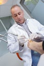 Senior woman receives foot examination from gloved podiatrist