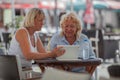 Senior women relaxing in cafe and using digital tablet Royalty Free Stock Photo