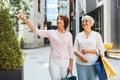 Senior women with shopping bags walking in city Royalty Free Stock Photo