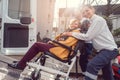 Senior woman in wheelchair being picked up by transport service Royalty Free Stock Photo