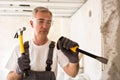 Senior worker demolish wall