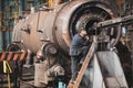 Senior worker in a dirty and old but still functioning metal works, old fashioned, factory