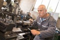 Senior worker doing shift at metalworks factory