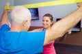 Senior working-out in physio room with personal trainer Royalty Free Stock Photo