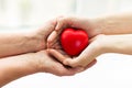 Senior and young woman hands holding red heart Royalty Free Stock Photo