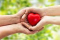 Senior and young woman hands holding red heart Royalty Free Stock Photo