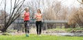 Senior and young woman running as sport on a meadow in spring Royalty Free Stock Photo