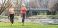 Senior and young woman running as sport on a meadow in spring Royalty Free Stock Photo