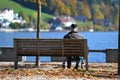 Seniors on a park bench from behind on the shore of the Mondsee, Mondsee, Upper Austria, Austria, Europe